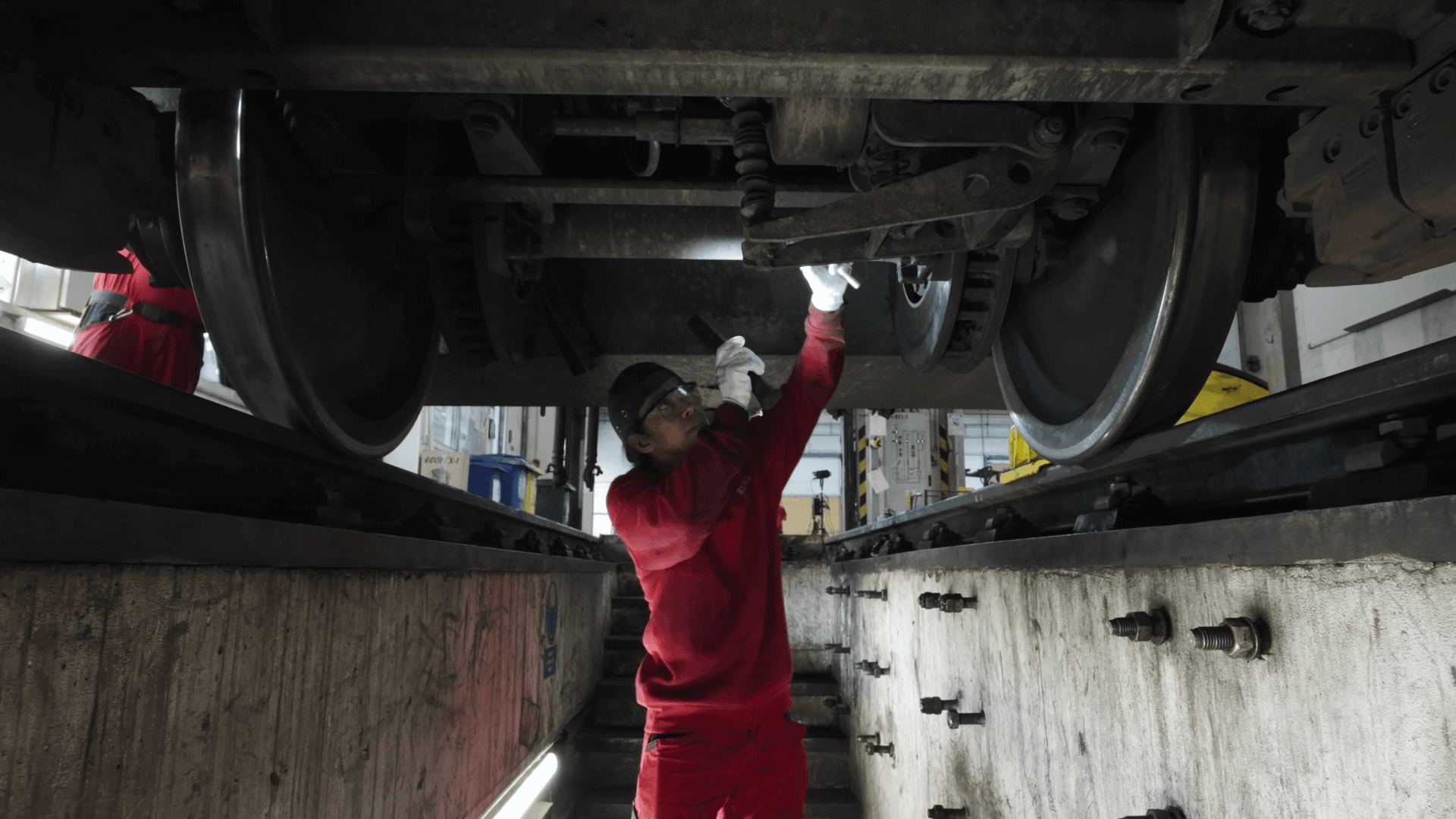 A mechanic working under a train carriage from the inspection pit
