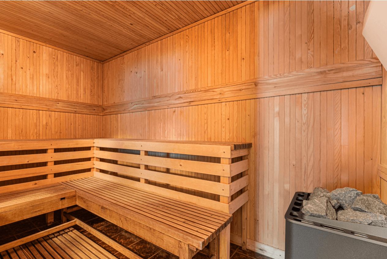 The sauna at the accommodation, wooden benches and a heater with stones
